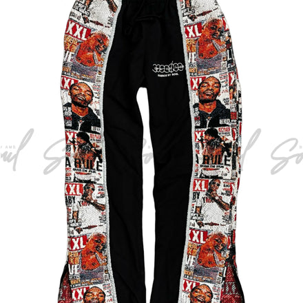 Pair of flared pants with black center and colorful graphic print side panels featuring cartoon characters and text.