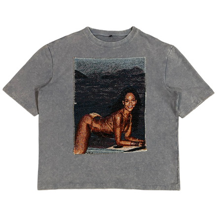 Gray t-shirt featuring a provocative image of a woman in a swimsuit posing on a beach.