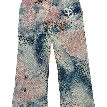 Patterned women’s trousers with a floral and snakeskin print.