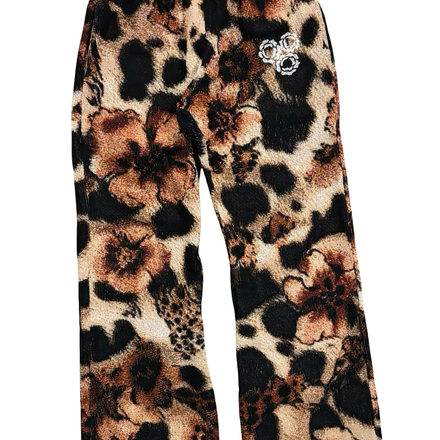 Leopard print pants with floral designs and rhinestone embellishments.