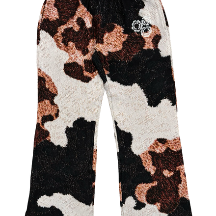 Cow print sweatpants with a small embroidered logo.