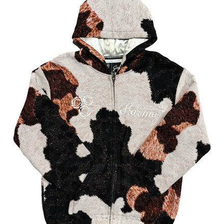 Hooded full-zip jacket with a cow print pattern in black, brown, and off-white.