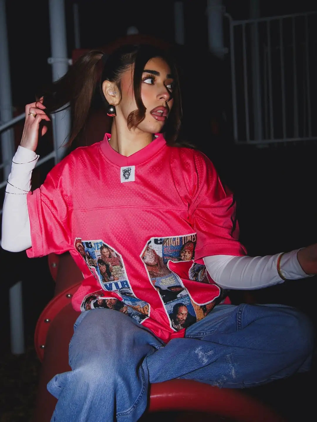 A vibrant pink mesh football jersey featuring a collage of magazine-style graphics and the word ’vib’ printed across the front.