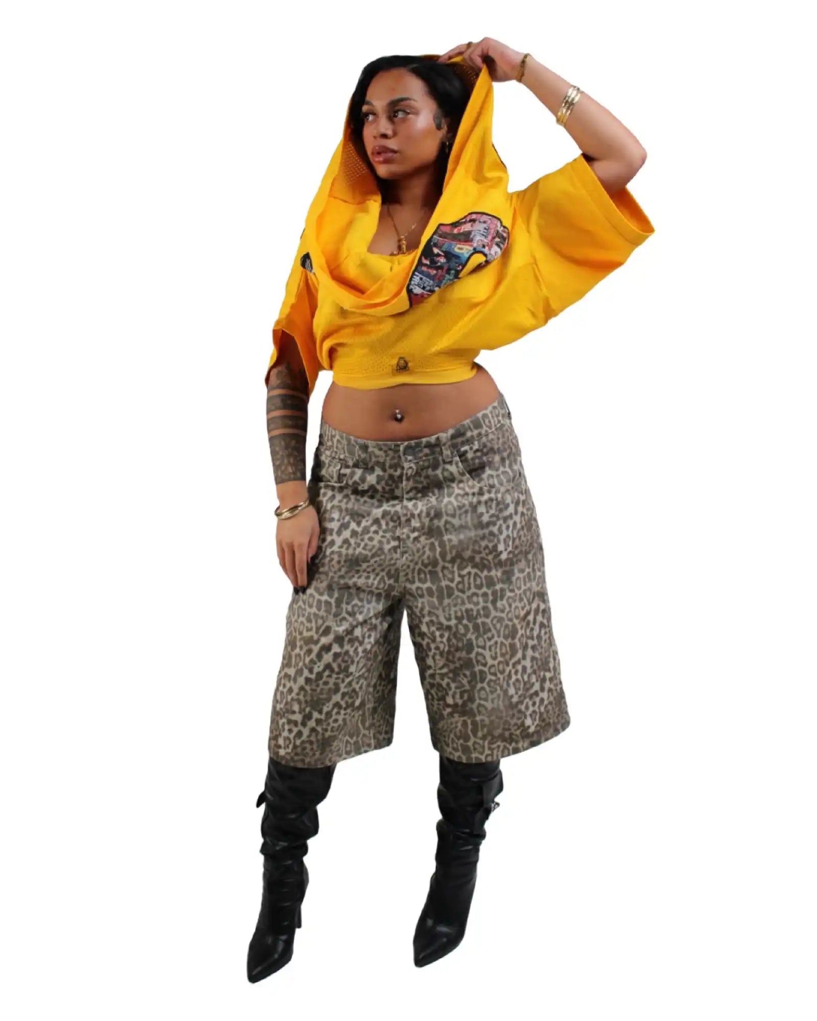 Woman in yellow hooded top and animal print culottes.
