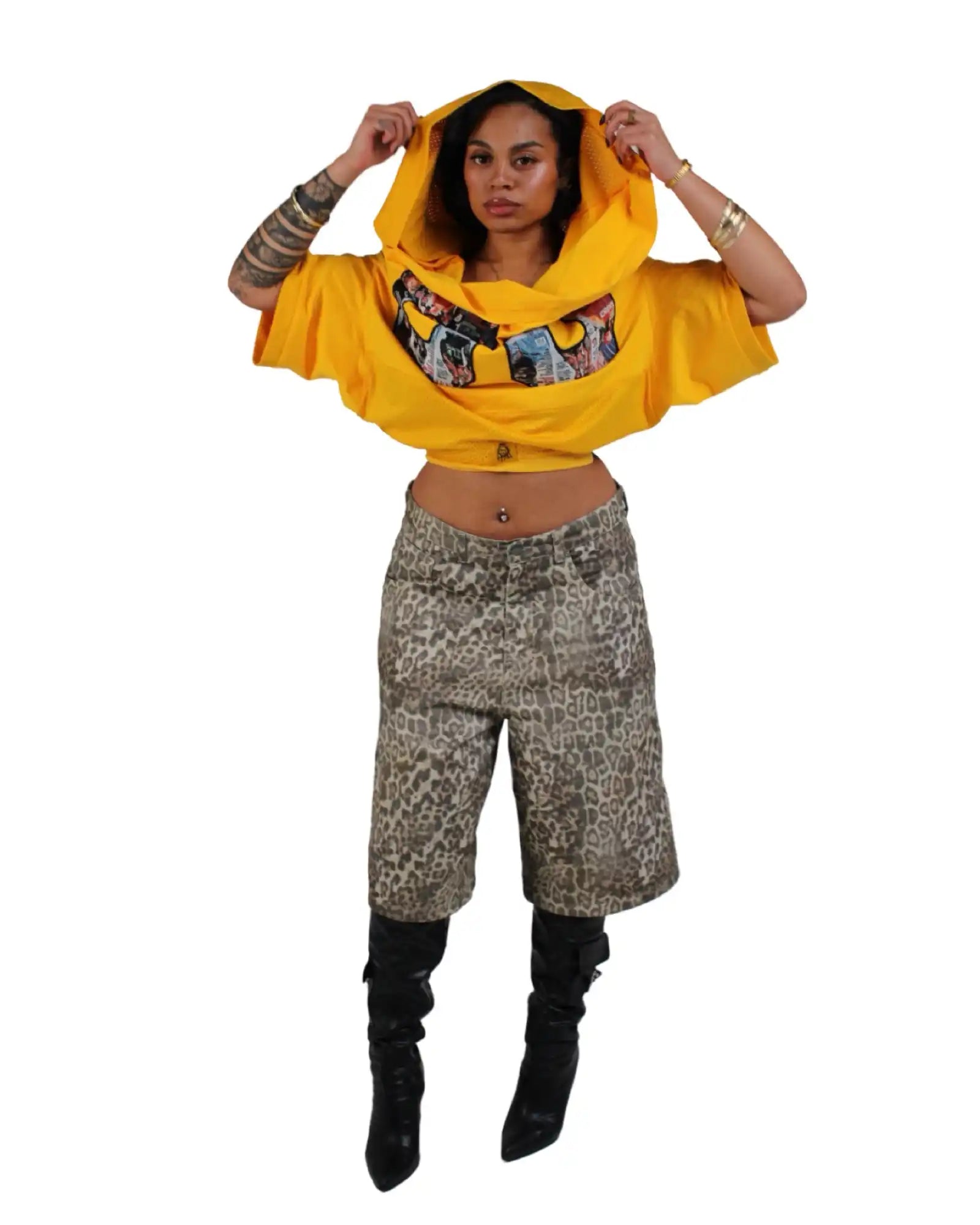 Woman in yellow hooded crop top and animal print culottes.