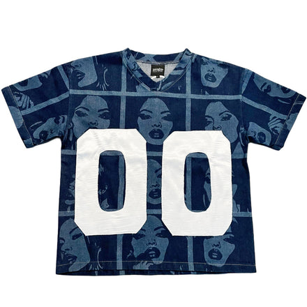 A dark blue short-sleeved t-shirt with a repeating pattern of women’s faces and two large white ’00’’ numbers on the front.