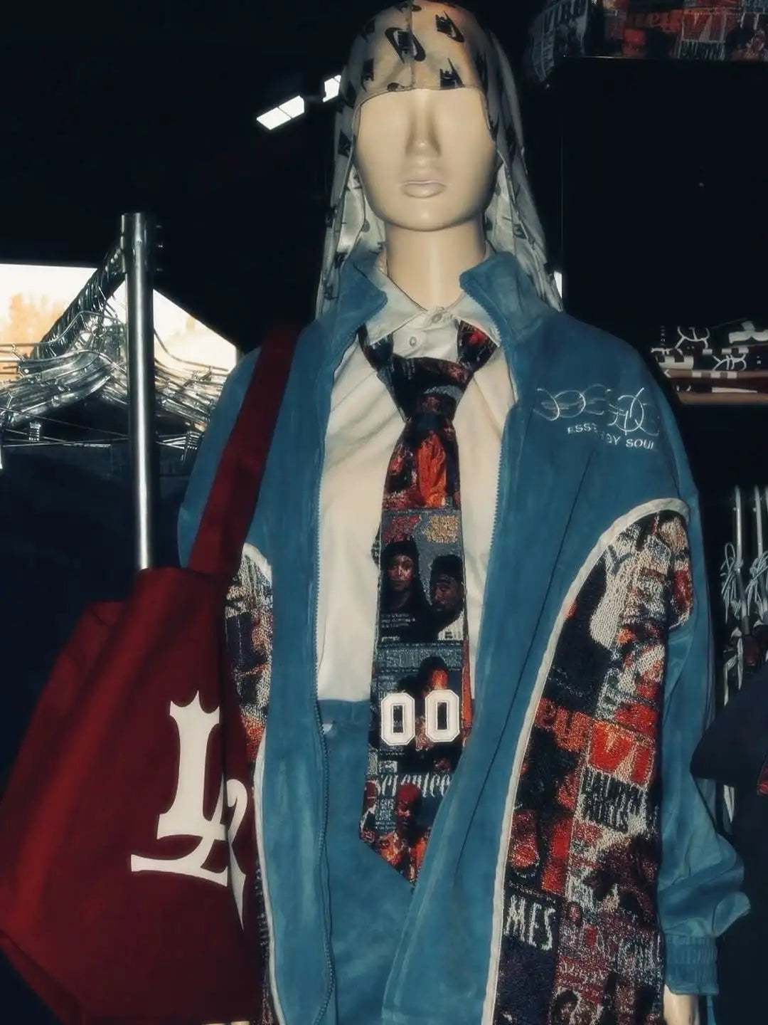 Blue denim jacket with graphic patches and embroidered logo