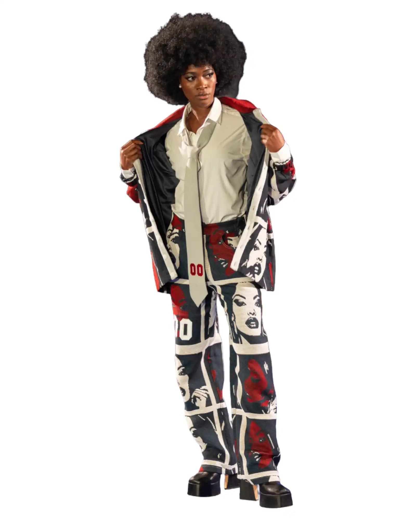A model showcasing a two-piece suit with a graphic print of faces in black, white, and red, paired with a light-colored button-up shirt and a matching tie.