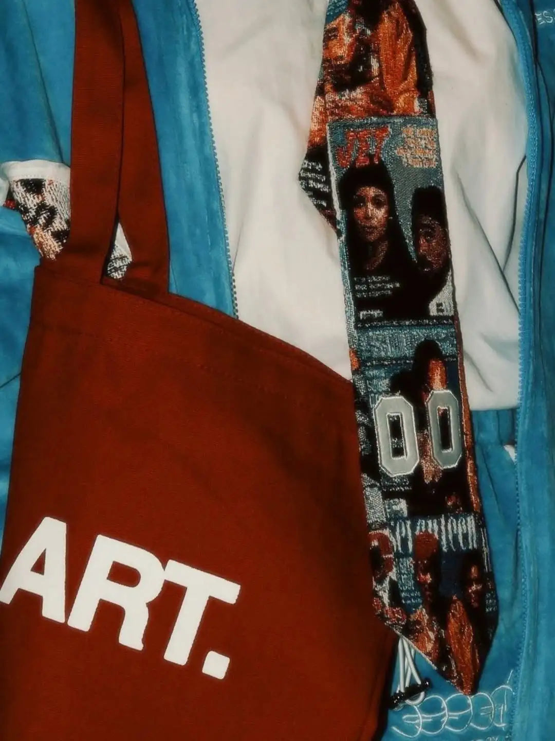 A rust-colored tote bag with bold white ’art.’ lettering.